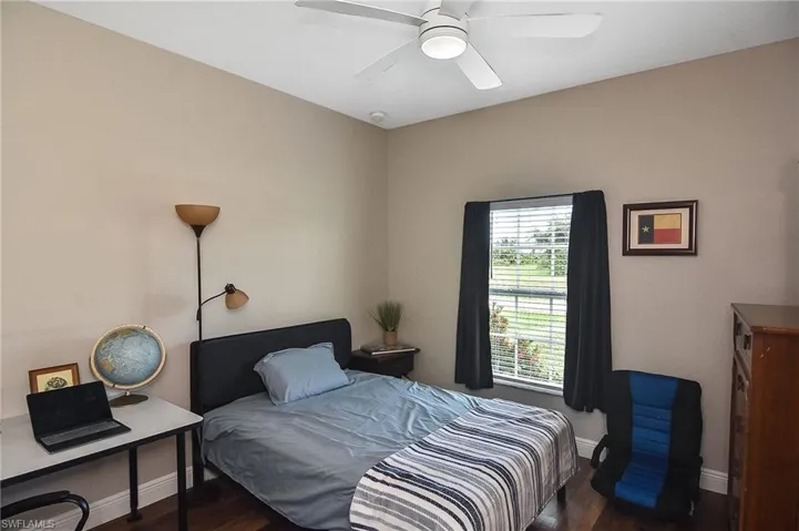 Bedroom with dark wood-style floors and ceiling fan