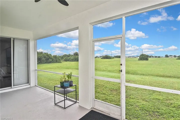 Unfurnished sunroom with a view of rural / pastoral area and a ceiling fan