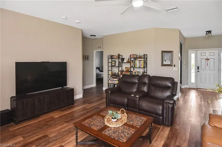 Living room featuring wood finished floors and ceiling fan