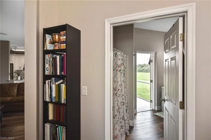 Corridor featuring dark wood-type flooring