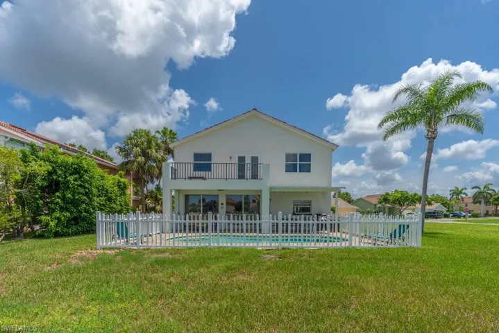 Back of property with a balcony and a patio