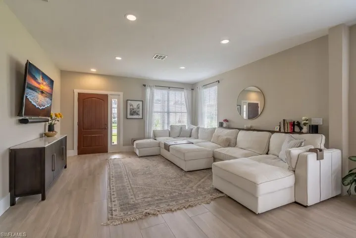 Living area featuring plenty of natural light, light wood-type flooring, and recessed lighting