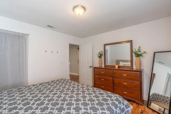 Bedroom featuring wood finished floors and baseboards