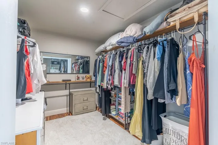 Spacious closet featuring attic access and wood finished floors