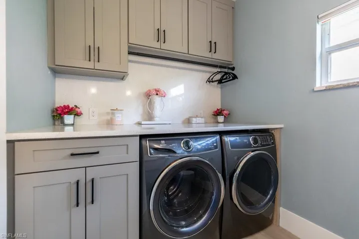 Laundry room with washing machine and dryer and cabinet space