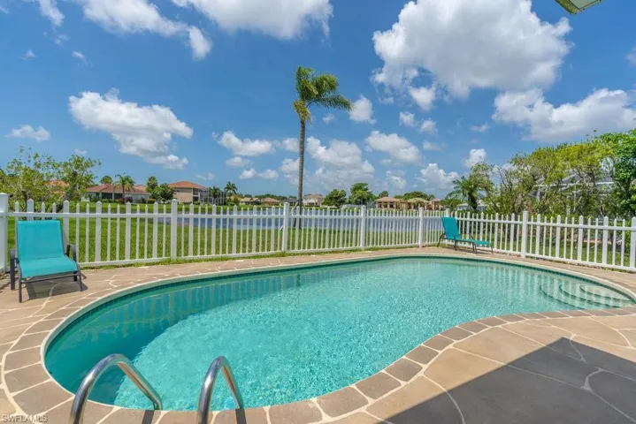 View of pool with a fenced backyard and a patio