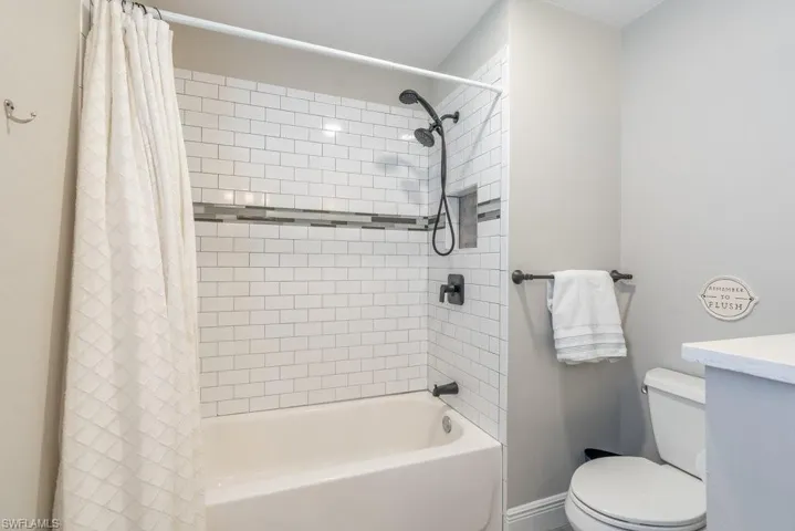 Full bathroom featuring shower / tub combo with curtain and vanity