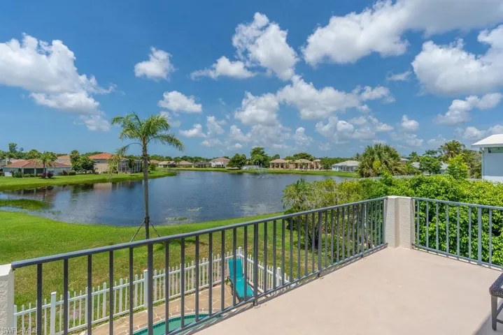 Balcony with a water view, a residential view, and view of pool