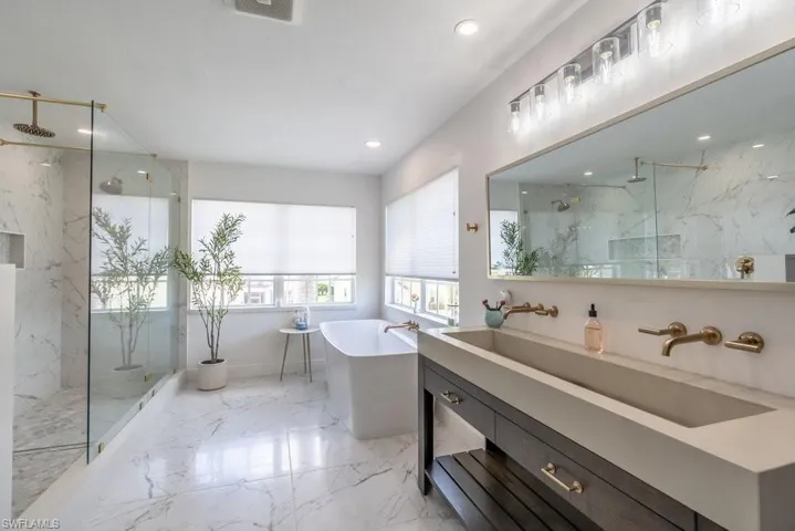 Full bathroom with a marble finish shower, vanity, a soaking tub, recessed lighting, and marble tiled floors
