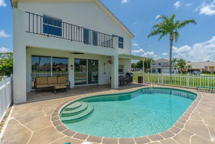 View of pool with a patio and a ceiling fan