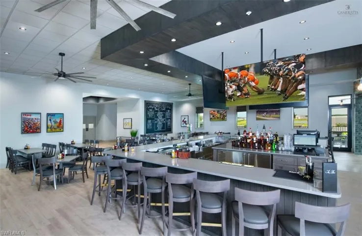 Kitchen featuring a kitchen bar, ceiling fan, and kitchen peninsula