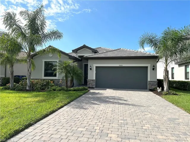 View of front facade with a garage and a front yard
