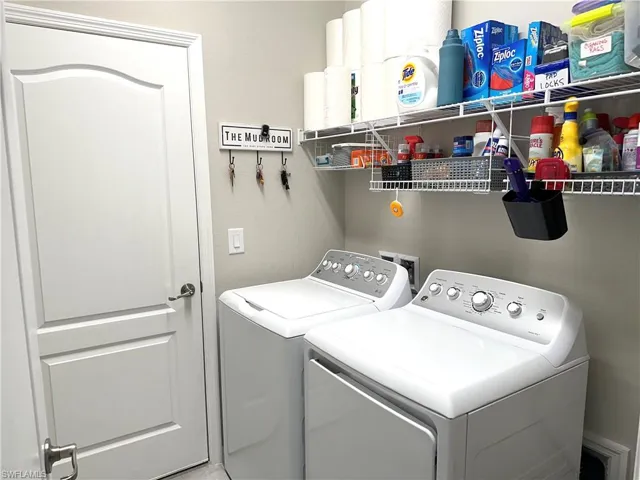 Clothes washing area featuring separate washer and dryer