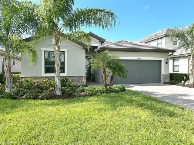 View of front of house featuring a garage and a front yard