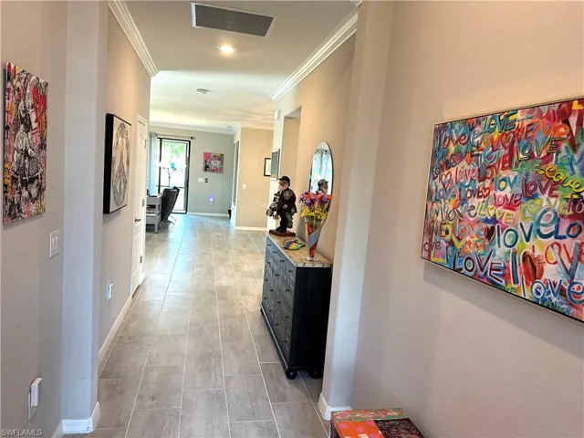 Corridor featuring crown molding