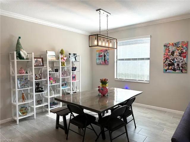 Dining space with ornamental molding and a textured ceiling