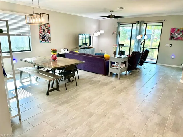 Dining room with crown molding and ceiling fan