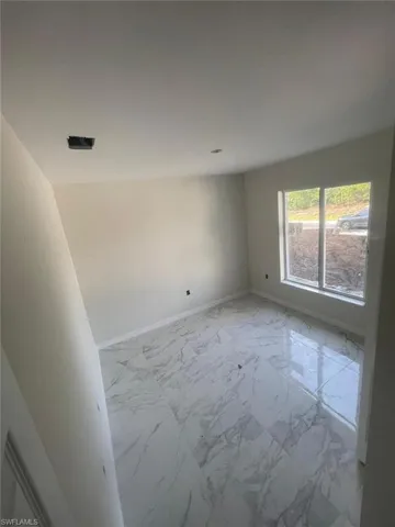 Unfurnished room featuring light tile flooring