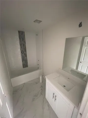 Bathroom featuring bathing tub / shower combination and vanity