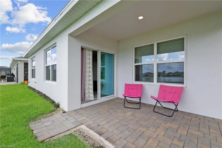 Covered patio featuring paver flooring, recessed lighting, and a sliding glass door