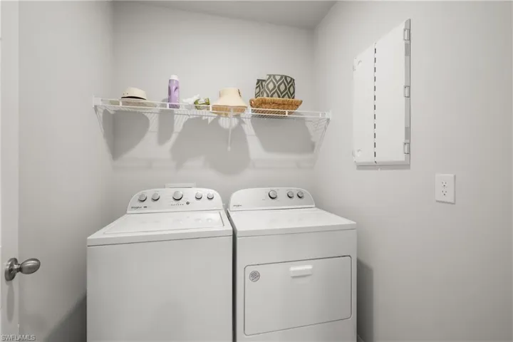 Dedicated laundry area featuring a white wire shelving unit