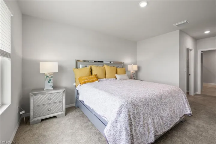 Interior room featuring neutral wall tones, recessed lighting, and carpet flooring