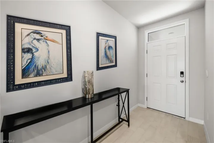 White paneled entry door with transom window