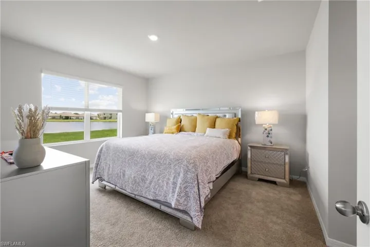 Bedroom featuring broad window, light wall paint, recessed lighting, and carpet flooring