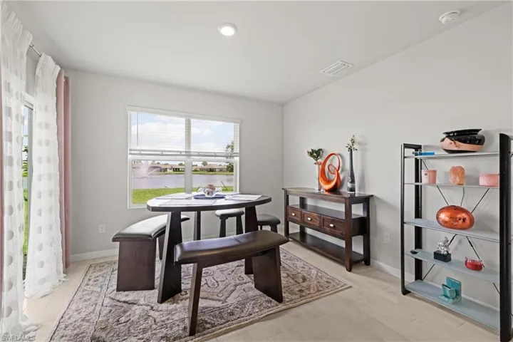 Light-toned wood-finish flooring complements the neutral wall color