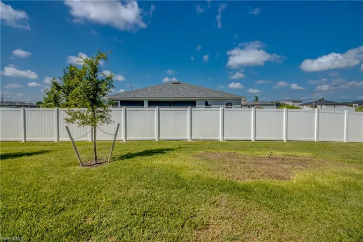 View of fenced-in backyard