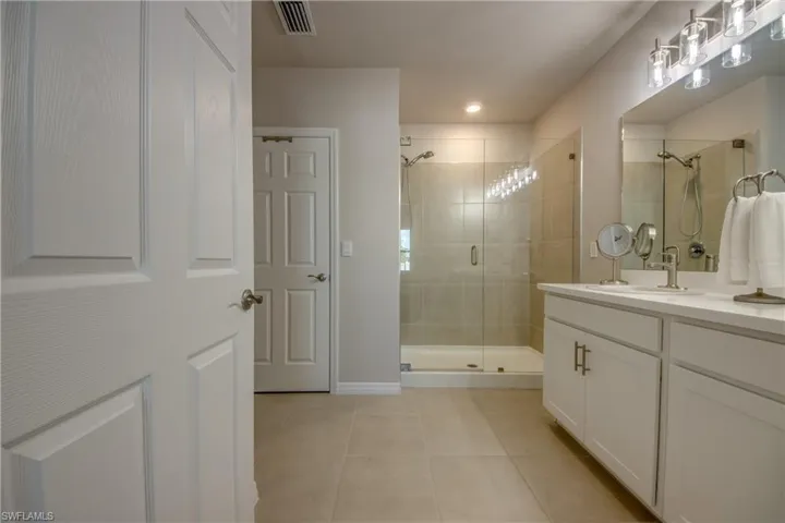 Primary bathroom with double sinks and walk-in shower
