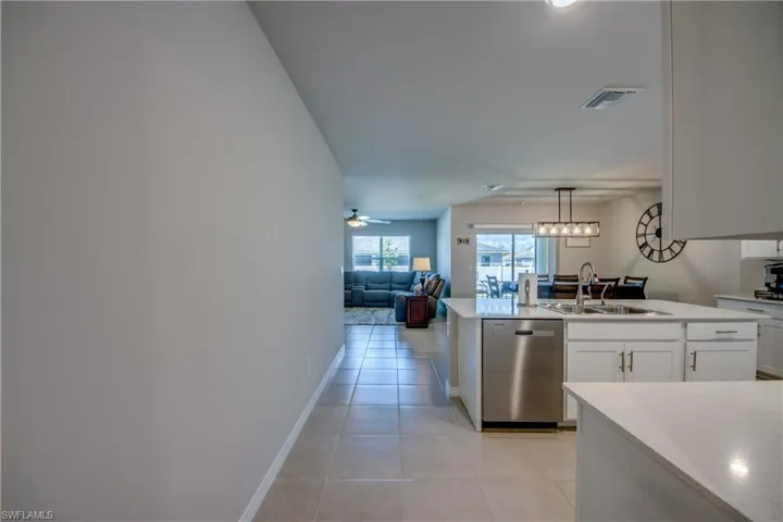 Kitchen featuring a large island, stainless steel appliances, quartz counters and designer cabinets