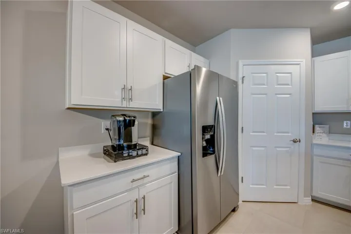 Kitchen featuring a large island, stainless steel appliances, quartz counters and designer cabinets