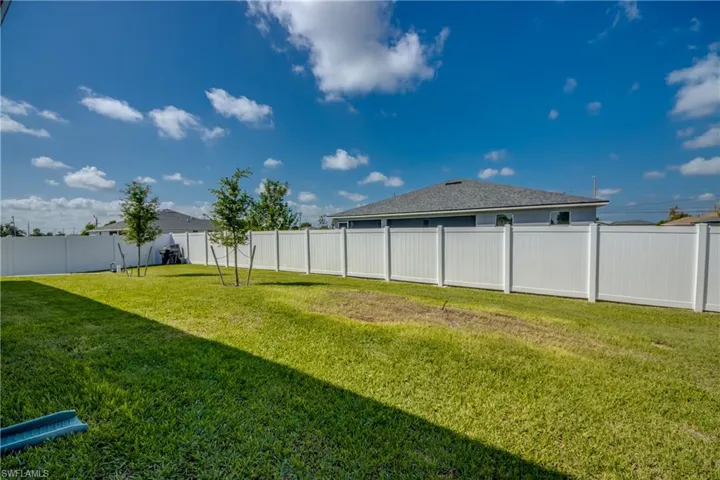 View of fenced-in backyard