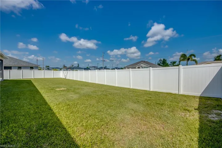 View of fenced-in backyard