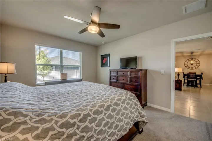 Primary suite featuring a large, luxurious bathroom and walk-in closet