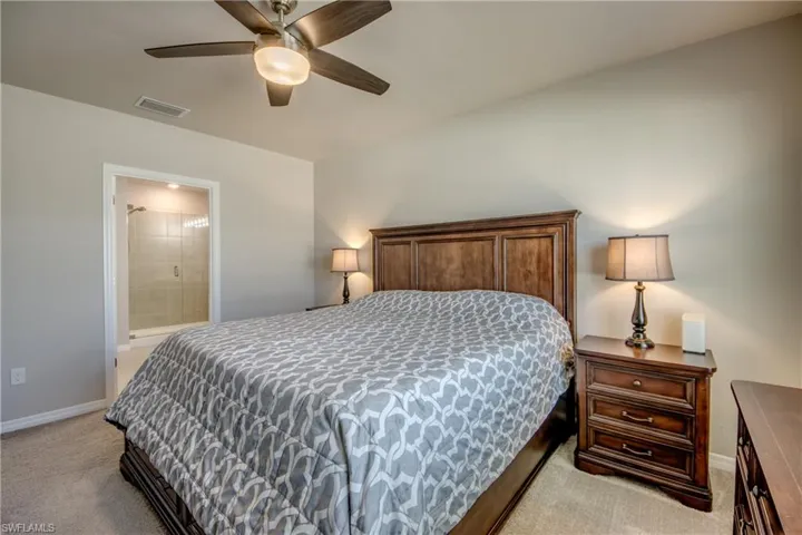 Primary suite featuring a large, luxurious bathroom and walk-in closet