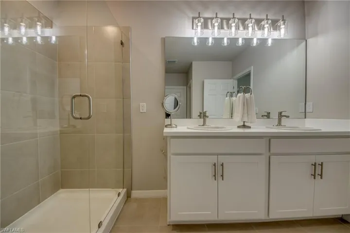 Primary bathroom with double sinks and walk-in shower