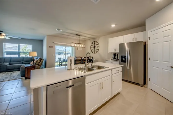 Kitchen featuring a large island, stainless steel appliances, quartz counters and designer cabinets