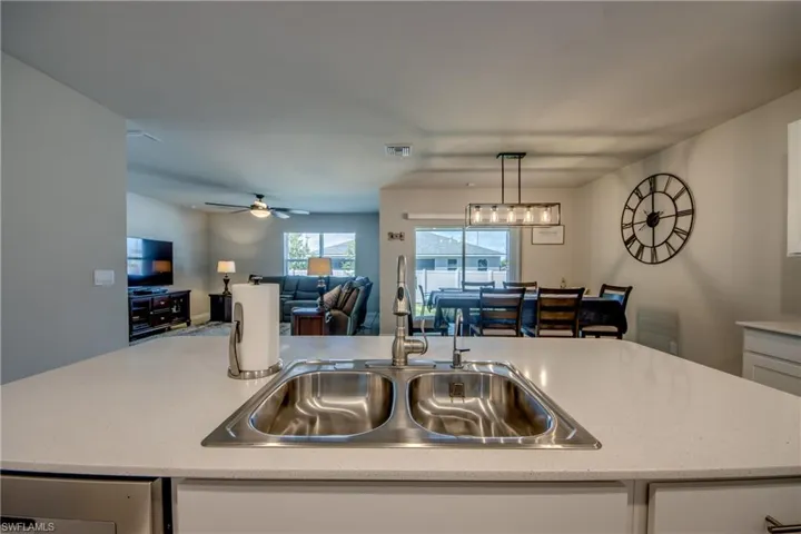 Kitchen featuring a large island, stainless steel appliances, quartz counters and designer cabinets