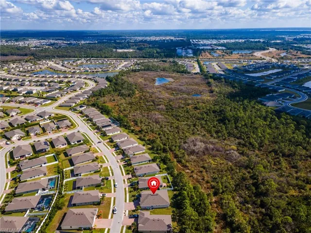 Aerial view of residential area featuring a nearby body of water
