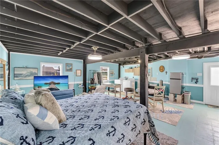 Bedroom featuring stainless steel fridge and washer / dryer