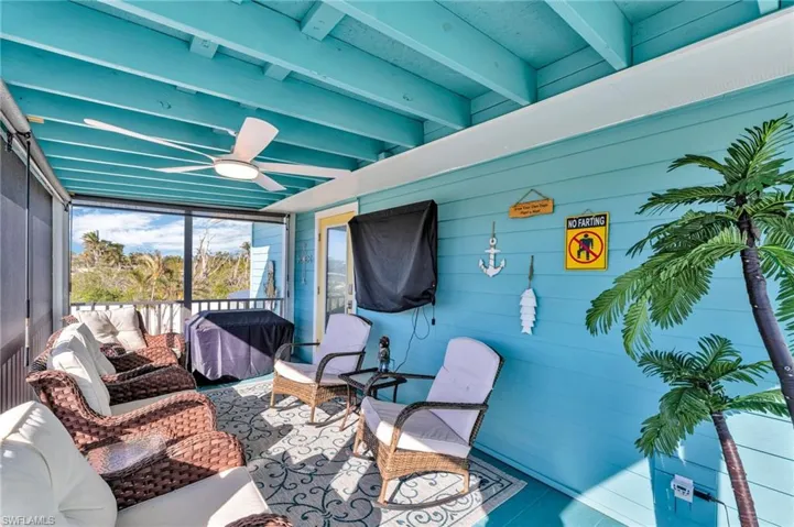 View of patio with ceiling fan, area for grilling, and an outdoor hangout area