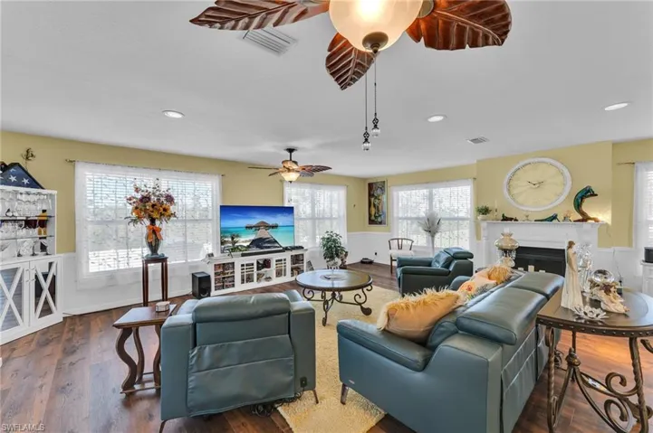 Living room with dark wood-type flooring