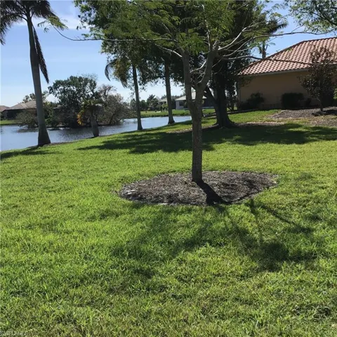 View of yard with a water view