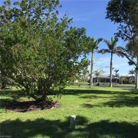 View of property's community with a yard