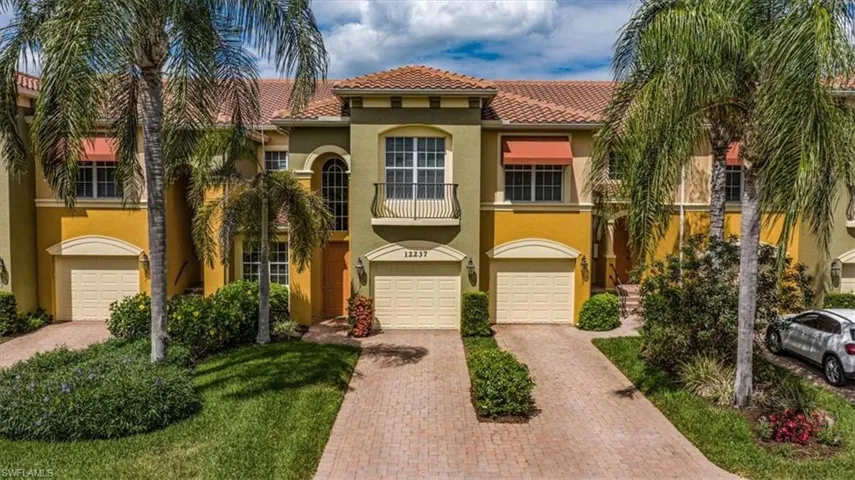Mediterranean / spanish-style home featuring driveway, an attached garage, a tile roof, and stucco siding