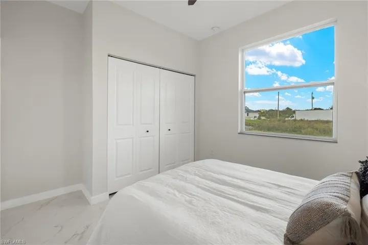 Bedroom featuring multiple windows, a closet, and ceiling fan