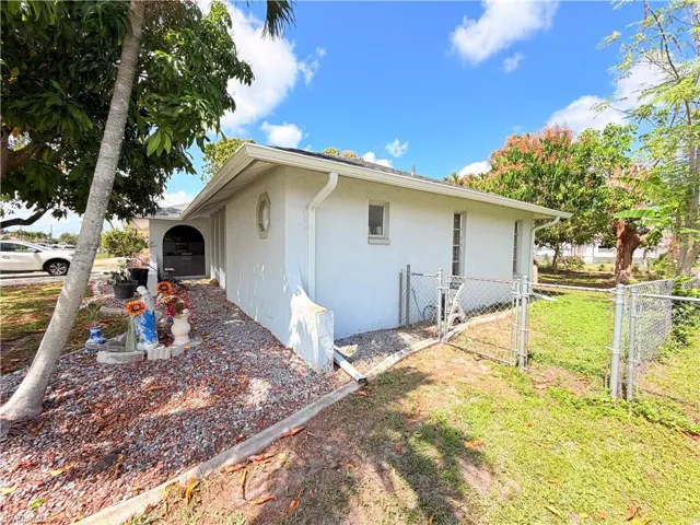 View of home's exterior with a gate and stucco siding