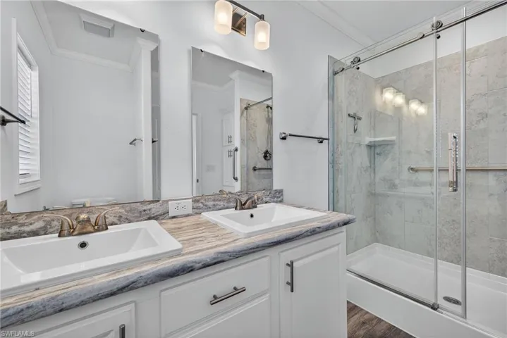 Bathroom with double vanity and shower stall